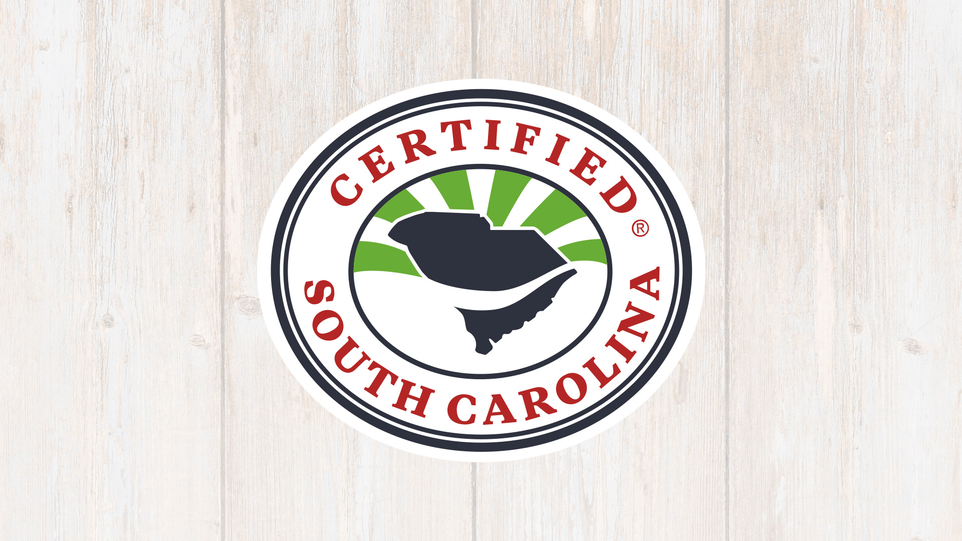 Circular logo featuring the words "CERTIFIED SOUTH CAROLINA" around a central graphic of the state of South Carolina, with green rays emanating from the top.